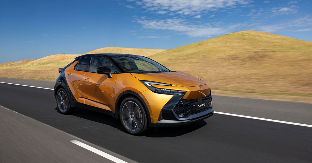 A new Toyota C-HR driving along a scenic road