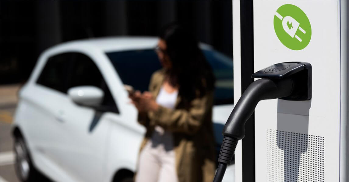 Lady waiting for EV to charge