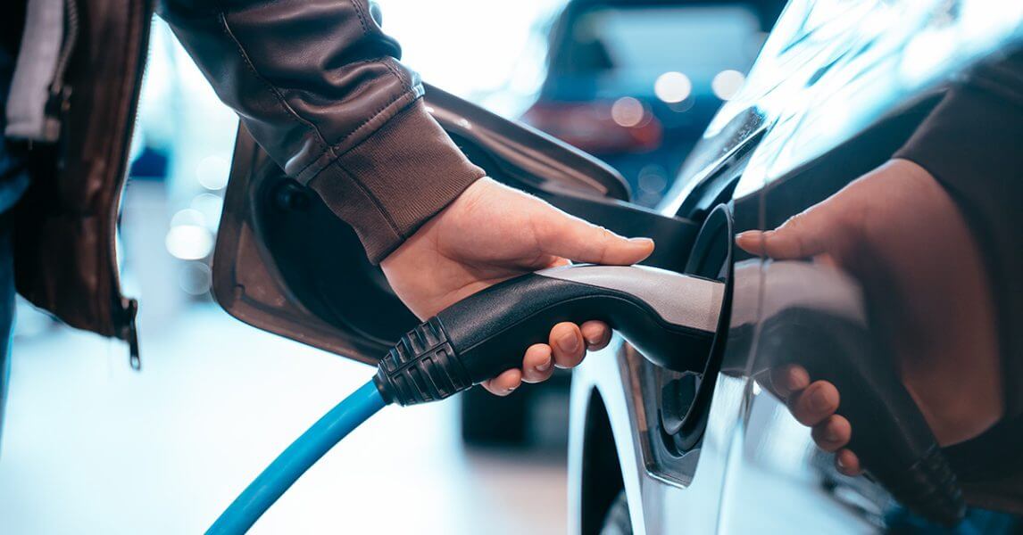 Man charging EV close-up