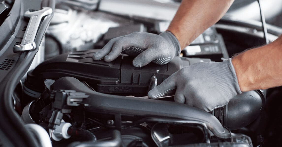 Man with glove fixing car