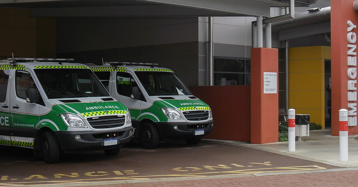 Two ambulances parked outside a hospital, ready to respond to emergencies and provide medical assistance.