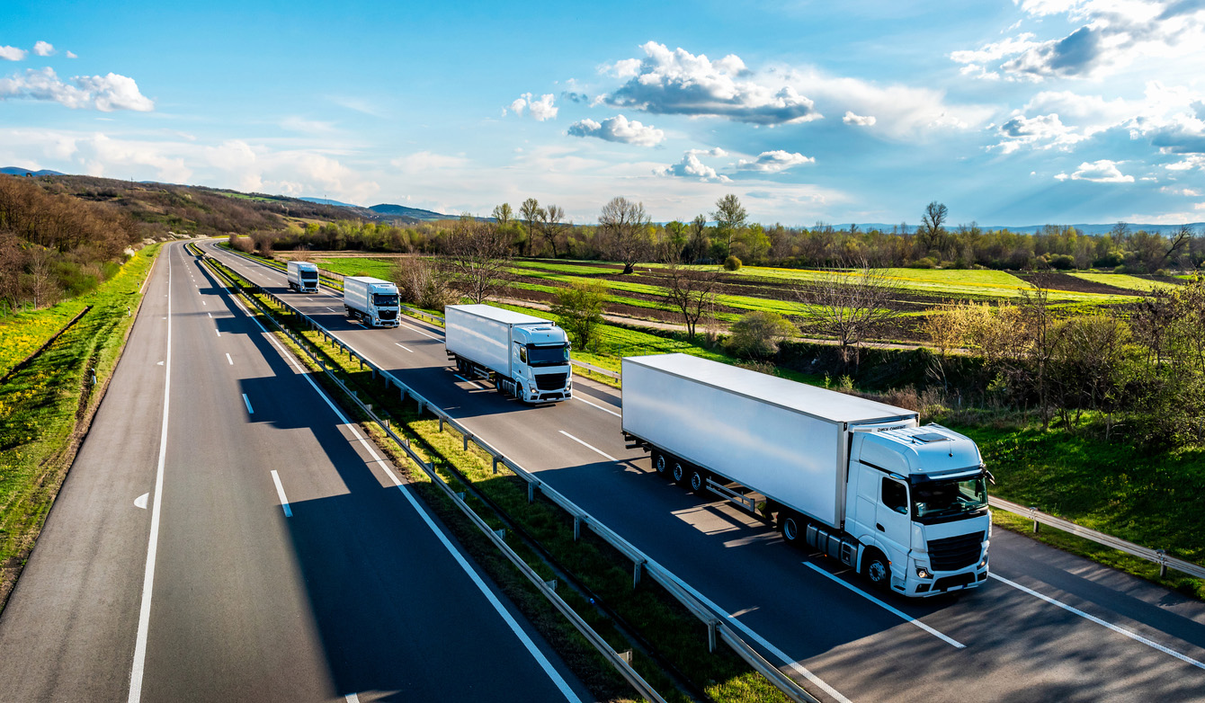 White Trucks with containers on highway