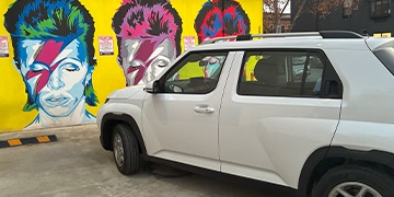 Hyundai INSTER Hyundai INSTER in white parked in front of a David Bowie urban mural