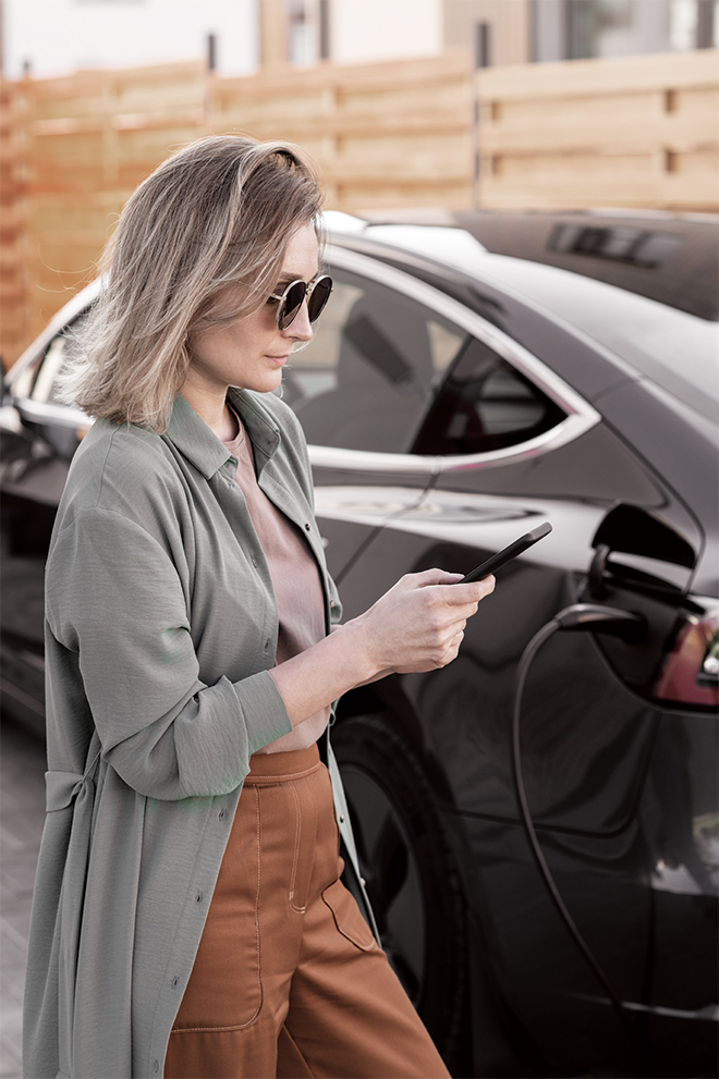 SGF_Onward_People_RGB_LR_22 Woman on phone in front of vehicle