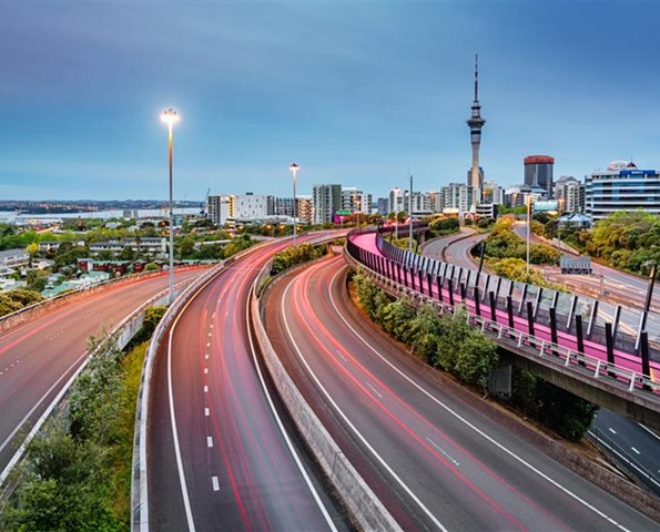 NZ Destination Auckland Auckland city with the Skytower in the background and state highway one and bike lane in the foreground