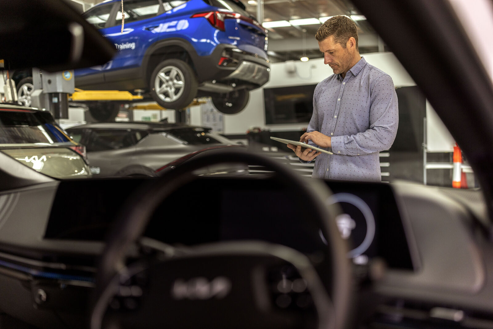 Mechanic reviewing tablet for vehicle service