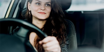 Woman driving checking rear view mirror