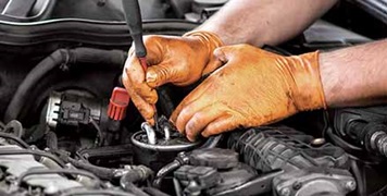 Mechanic wearing orange gloves
