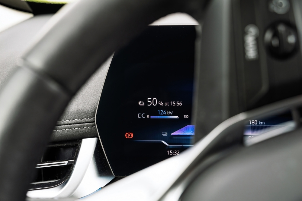 2026 electric cars range: Electric vehicle dashboard showing battery charge level, remaining range, and charging power on a digital display