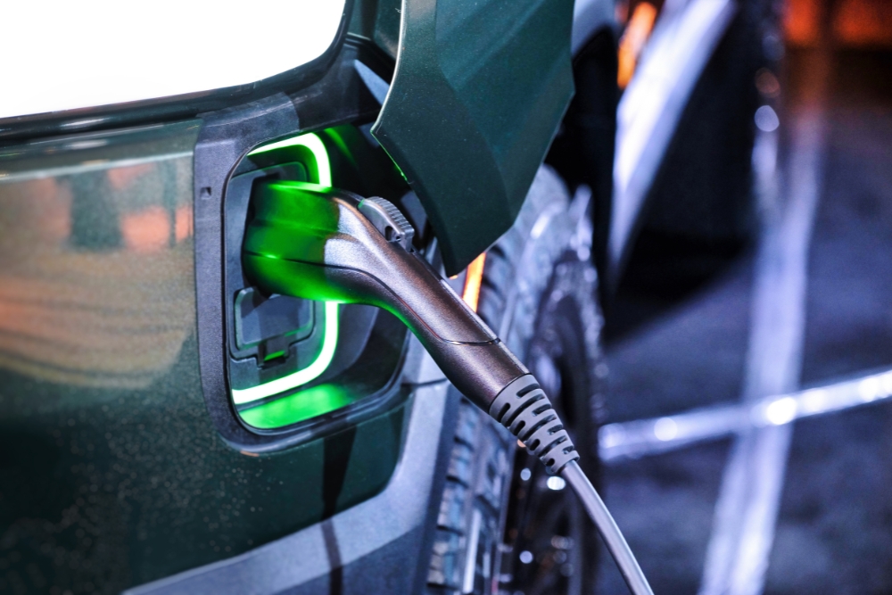 Electric vehicle charging at a public charge point, highlighting how the 2025 Budget may influence EV uptake and infrastructure.